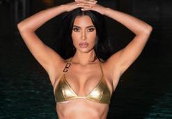 Kim Kardashian tanga bikinisiyle bisiklete binip havuz kenarında tur attı