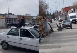 Otomobilin tavanında yolculuk yaparken yere çakıldı